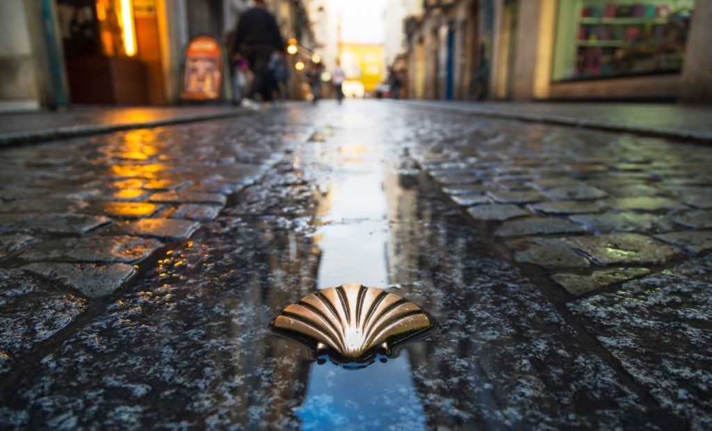 The Camino Shell on a rainy street in Spain